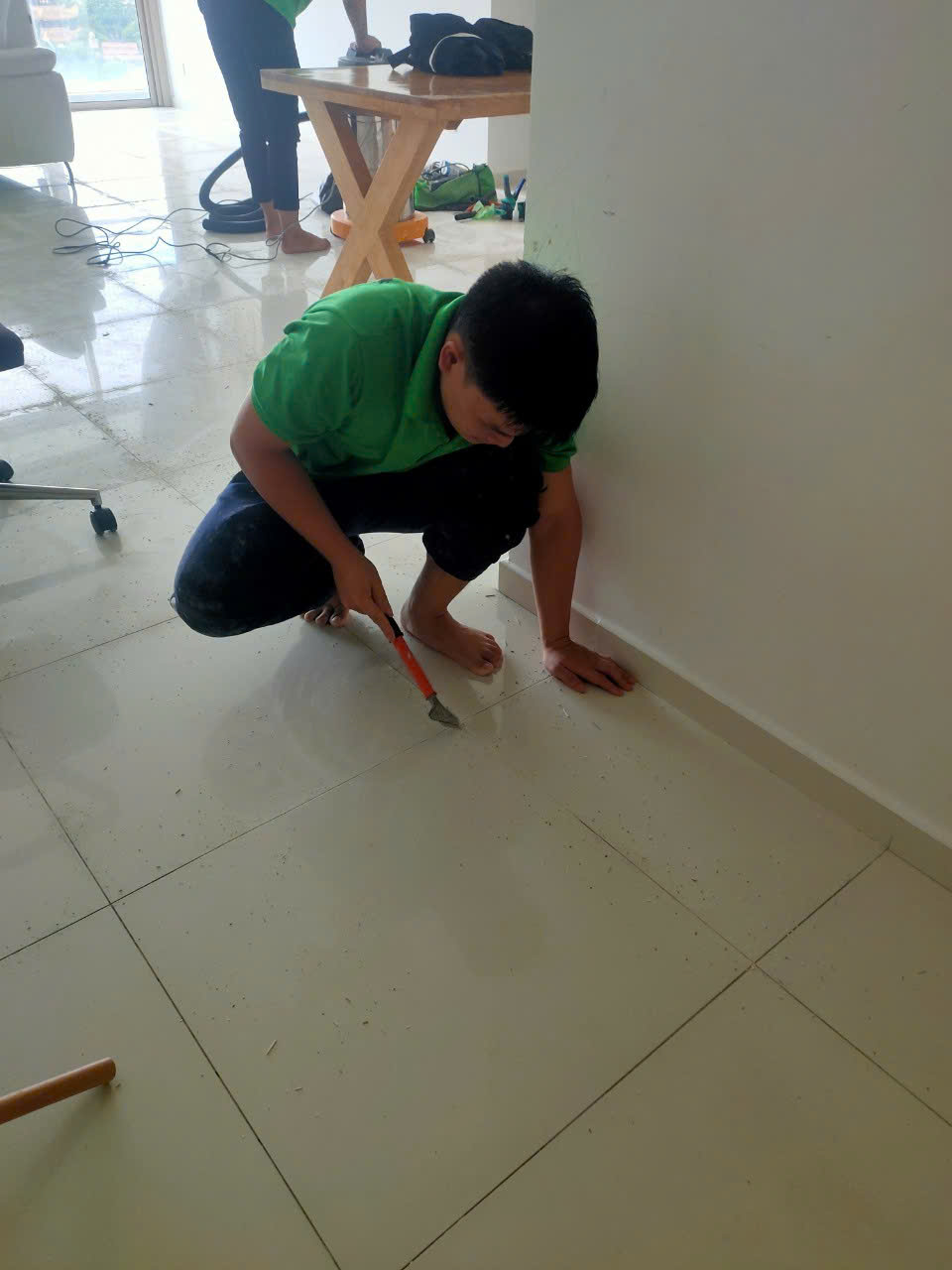 Thợ đang xử lý khe ron sàn nhà tỉ mỉ